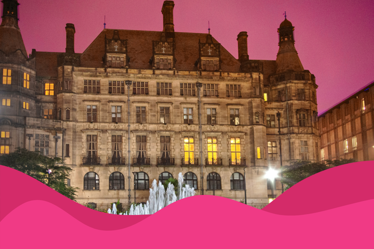 Image of Sheffield city hall with pink light behind in article about digital marketing in Sheffield and the importance of local seo
