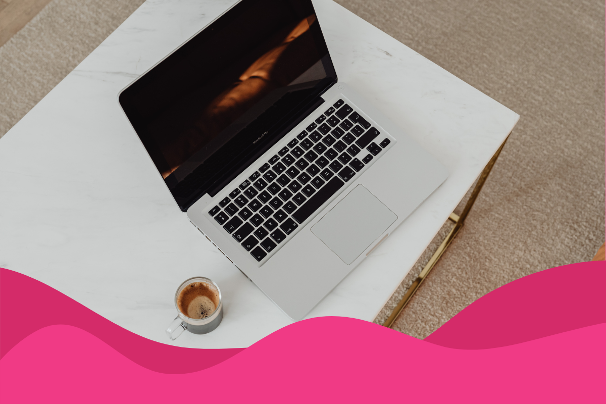 Image of an open macbook on a white desk against a cream carpet, with a cup of coffee next to it in an article about why you should invest in digital marketing as an SME in Sheffield, South Yorkshire by Daffodil Marketing.