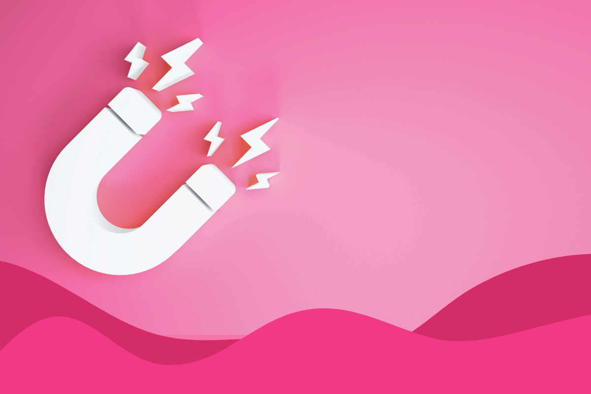 image of a pink background with grey magnet attracting lightning bolts in an article titled what is a lead magnet by Daffodil Marketing in Sheffield, South Yorkshire